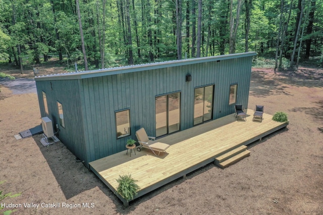 377 Pennsylvania Ave, Palenville, NY 12463 - back of property with a deck, a view of trees, and a metal roof