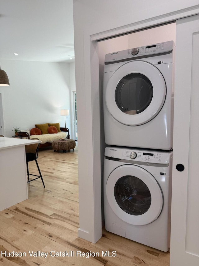 377 Pennsylvania Ave, Palenville, NY 12463 - washroom featuring stacked washing machine and dryer and light wood-style flooring