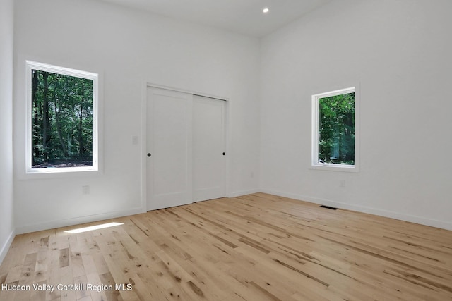 377 Pennsylvania Ave, Palenville, NY 12463 - unfurnished bedroom featuring multiple windows, wood finished floors, a closet, and recessed lighting