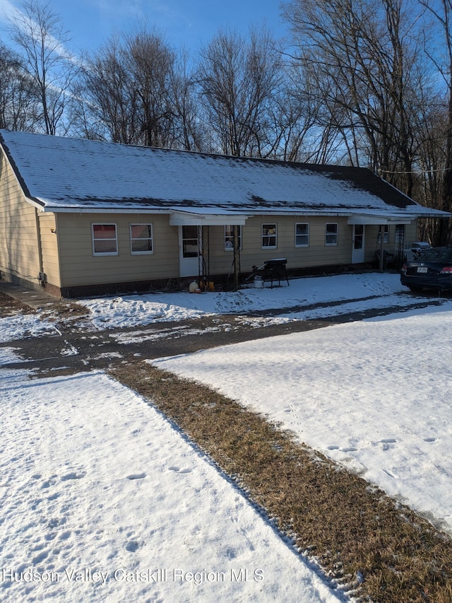 view of snow covered rear of property