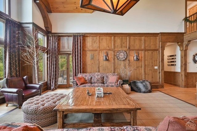 19 Twin Maples Ln, Windham, NY 12496 - living area with wood finished floors, wood walls, wainscoting, and a high ceiling