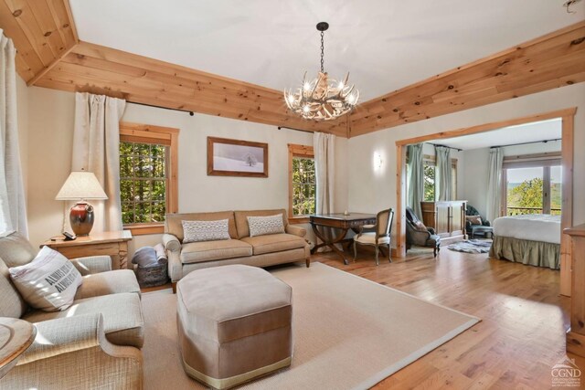 19 Twin Maples Ln, Windham, NY 12496 - living room featuring wood finished floors, a chandelier, and plenty of natural light