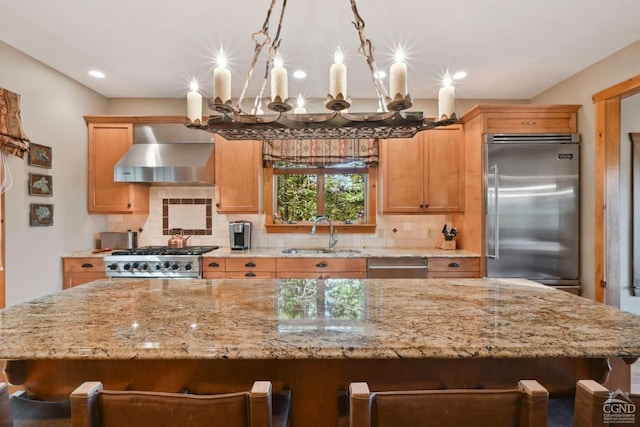 19 Twin Maples Ln, Windham, NY 12496 - kitchen featuring a sink, wall chimney range hood, stainless steel appliances, a chandelier, and decorative backsplash