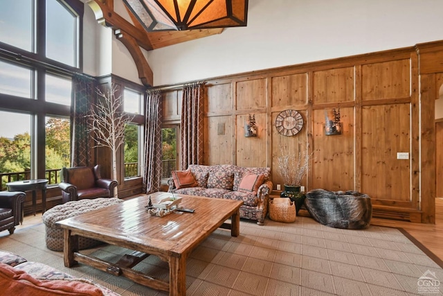 19 Twin Maples Ln, Windham, NY 12496 - living area featuring a high ceiling, wooden walls, and wood finished floors