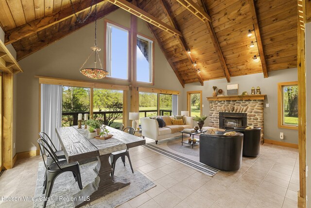 172 Stone Dock Rd, High Falls, NY 12440 - living area featuring wood ceiling, high vaulted ceiling, plenty of natural light, beamed ceiling, and a stone fireplace