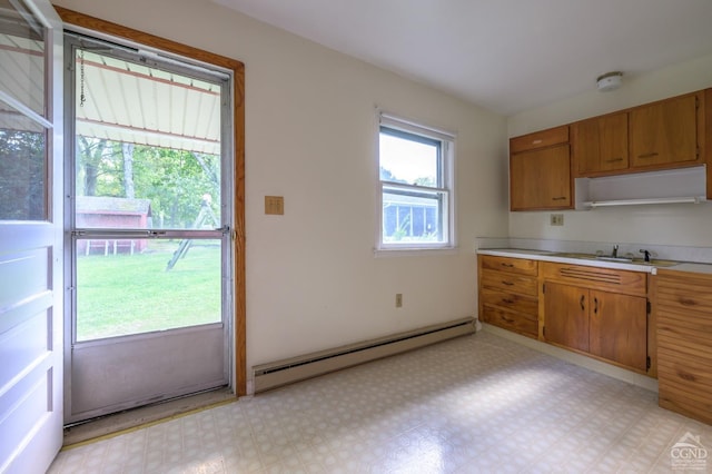 460 Joslen Blvd, Hudson, NY 12534 - kitchen featuring a baseboard radiator, light countertops, brown cabinets, a sink, and light floors