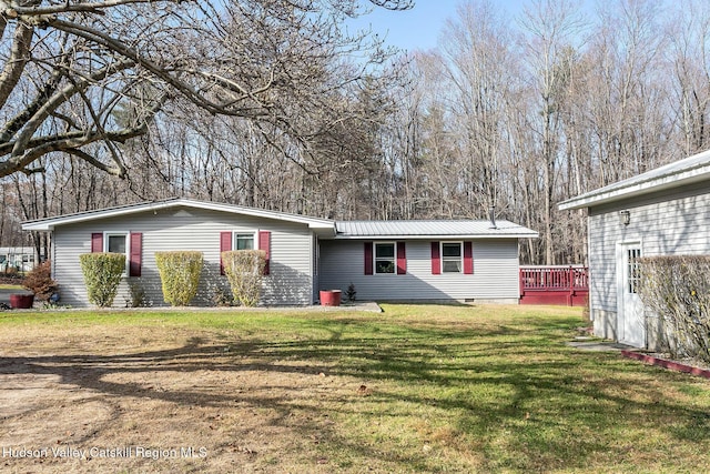 view of front of home featuring a front yard and a wooden deck