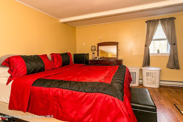 bedroom with hardwood / wood-style floors, beamed ceiling, and a baseboard radiator