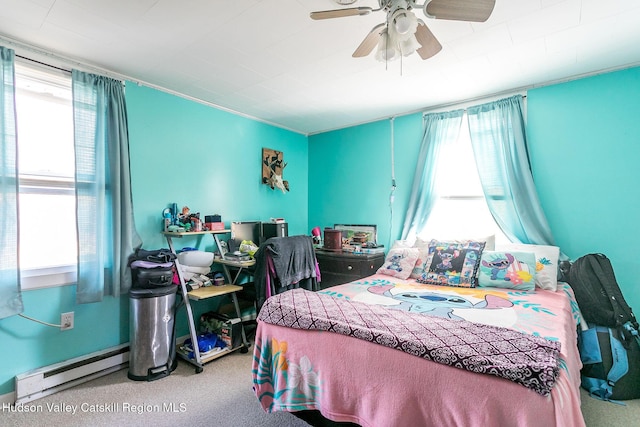 bedroom featuring carpet, multiple windows, a baseboard heating unit, and ceiling fan