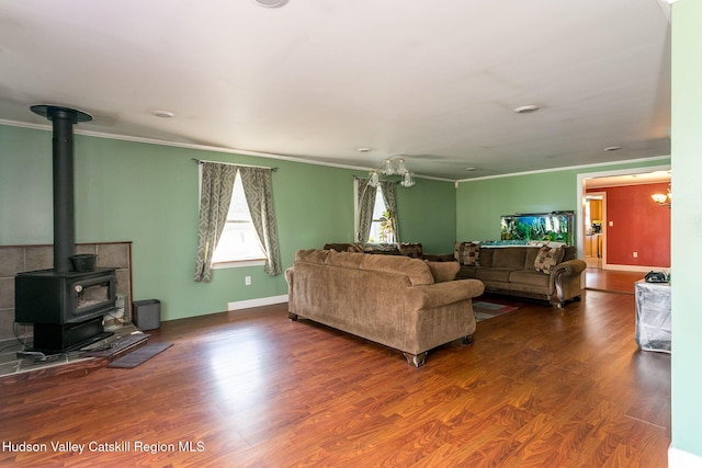 living room with dark hardwood / wood-style floors, a wood stove, and ornamental molding