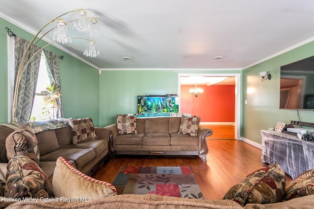 living room with crown molding, a notable chandelier, and hardwood / wood-style flooring