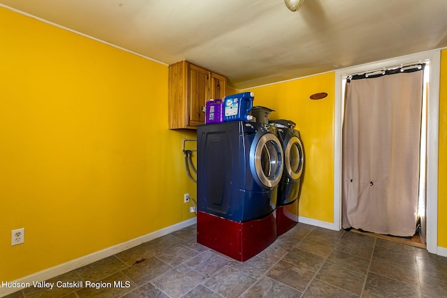 washroom with cabinets and washer and clothes dryer