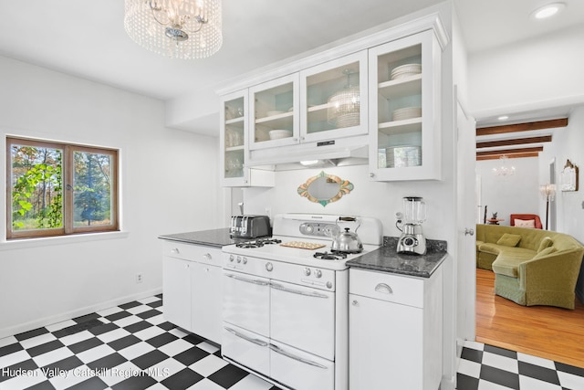 kitchen featuring dark hardwood / wood-style flooring, white range oven, white cabinetry, and a notable chandelier