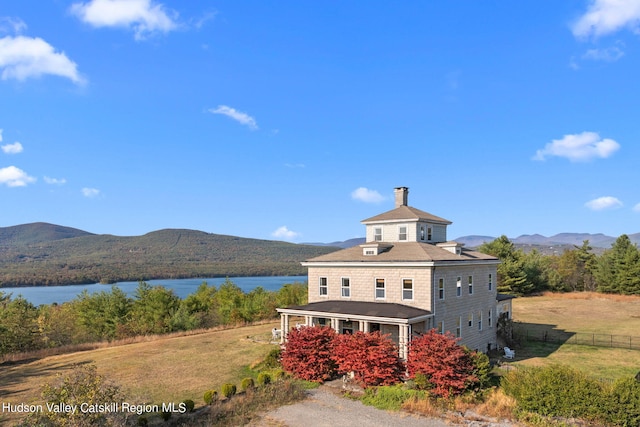 exterior space with a water and mountain view