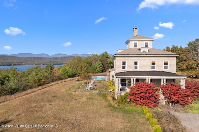 exterior space with a mountain view and a lawn