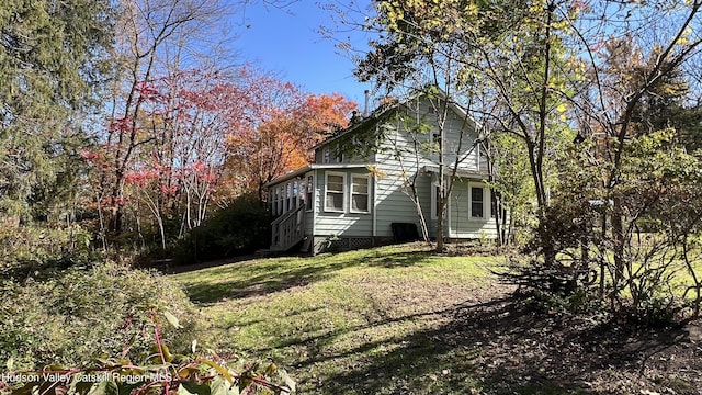 view of home's exterior featuring a yard and a sunroom