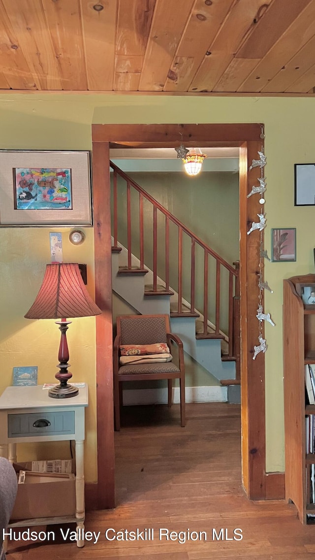 stairs with wood-type flooring and wood ceiling