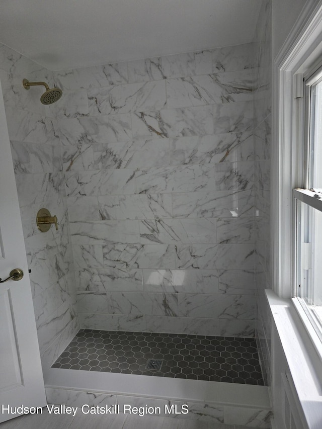 full bath featuring tiled shower