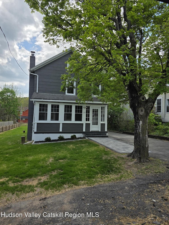 view of front of home with a chimney and entry steps