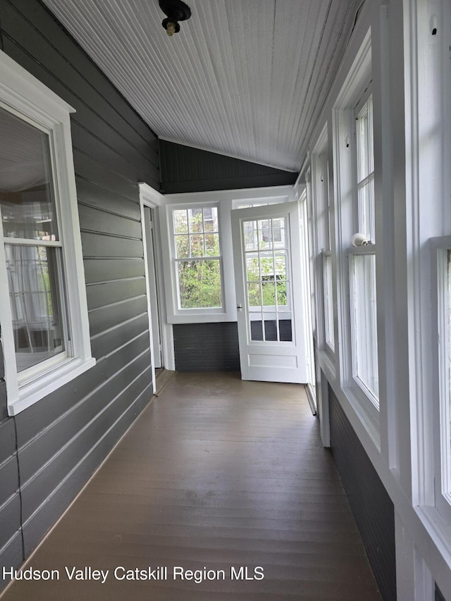 unfurnished sunroom featuring lofted ceiling and wood finished floors