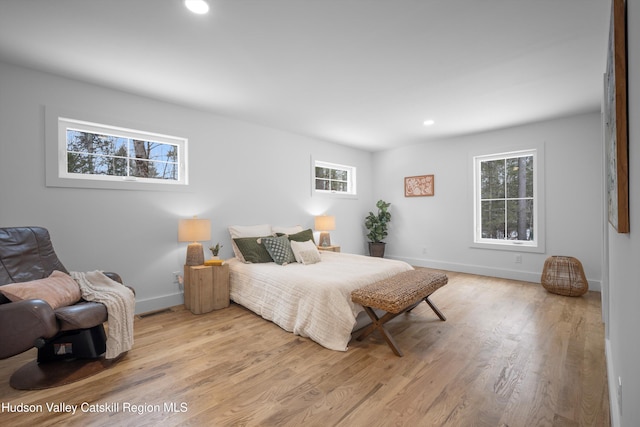 bedroom with recessed lighting, wood finished floors, visible vents, and baseboards