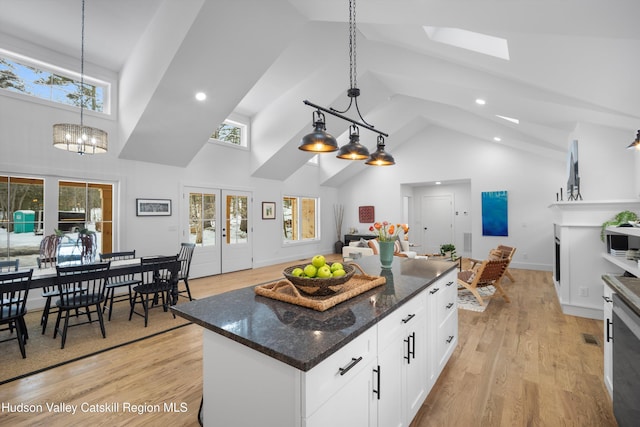 kitchen with light wood finished floors, white cabinets, a wealth of natural light, and french doors