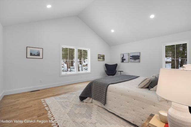 bedroom featuring baseboards, high vaulted ceiling, wood finished floors, and recessed lighting