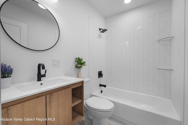 bathroom with shower / washtub combination, vanity, and toilet