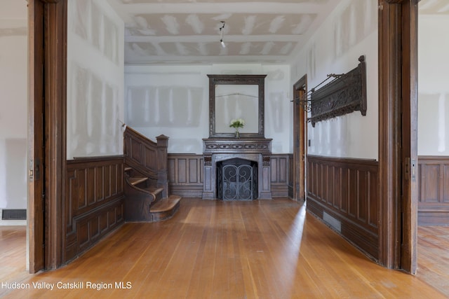 12 W Chestnut St, Kingston, NY 12401 - living area with hardwood / wood-style flooring, a fireplace, stairway, and a wainscoted wall