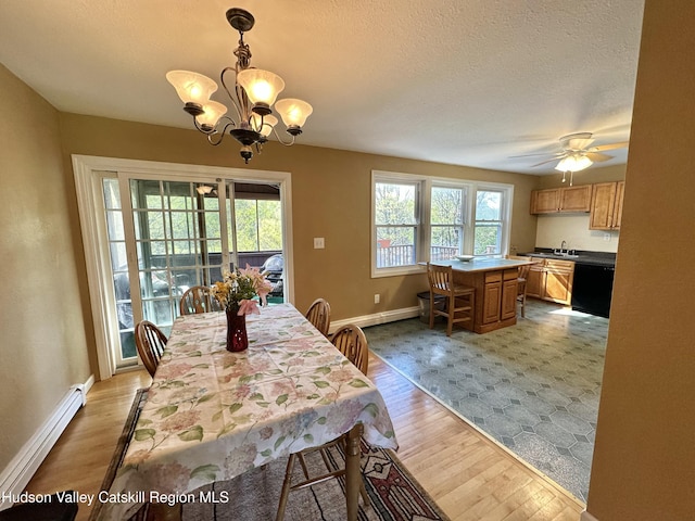 36 Susi Oval, Modena, NY 12548 - dining room with a baseboard heating unit, light wood-type flooring, baseboards, a chandelier, and a textured ceiling