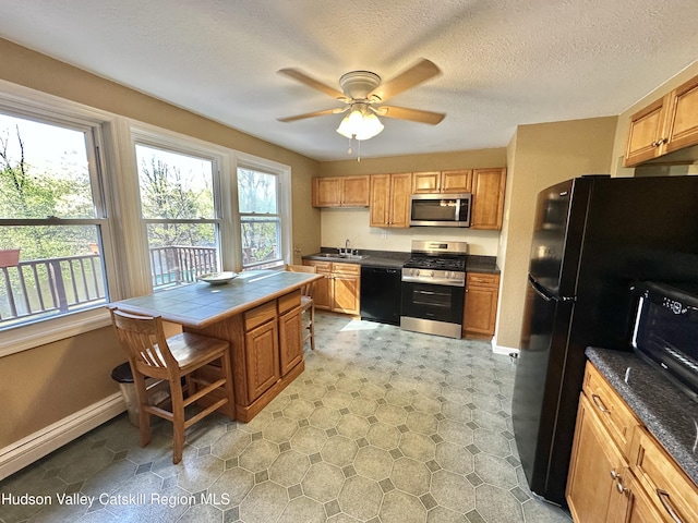 36 Susi Oval, Modena, NY 12548 - kitchen with black appliances, baseboards, tile countertops, a sink, and a ceiling fan
