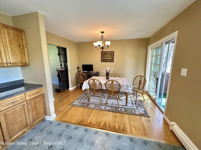 36 Susi Oval, Modena, NY 12548 - dining room with baseboard heating, a chandelier, baseboards, and wood finished floors