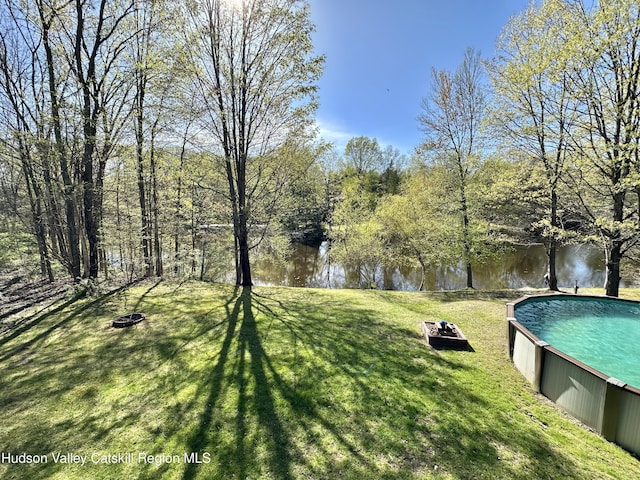 36 Susi Oval, Modena, NY 12548 - view of green lawn with a fire pit, an outdoor pool, and a water view