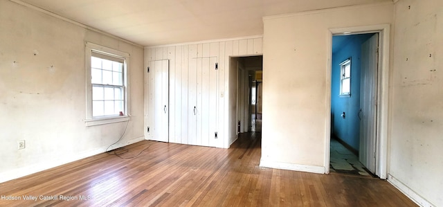 unfurnished bedroom featuring dark hardwood / wood-style flooring and ornamental molding