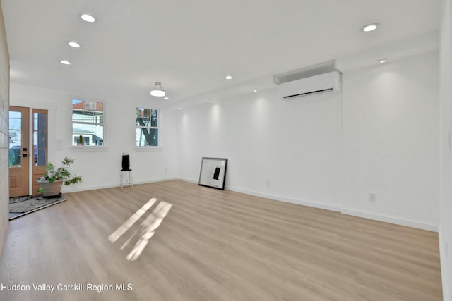 interior space featuring a wall unit AC and light wood-type flooring