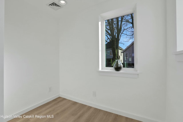 empty room with hardwood / wood-style flooring