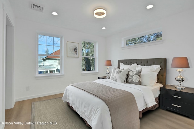 bedroom featuring light wood-type flooring and multiple windows