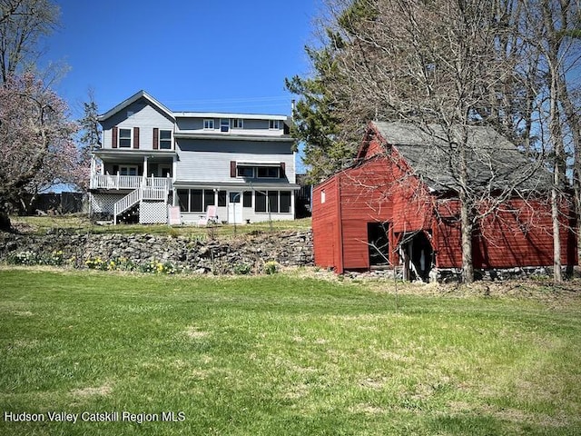 back of property with a lawn