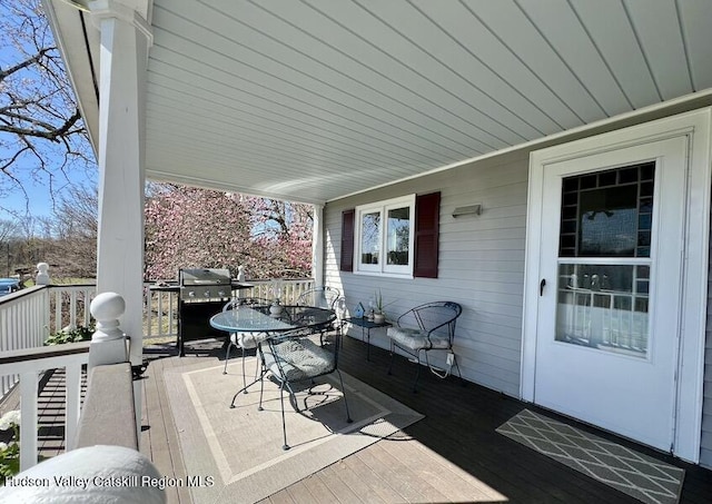 deck with outdoor dining area and area for grilling