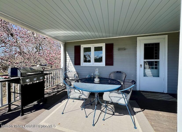 view of patio featuring a wooden deck and outdoor dining space