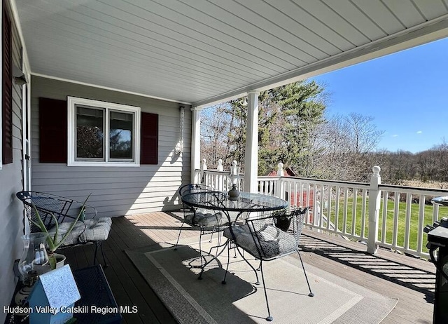 deck featuring outdoor dining area