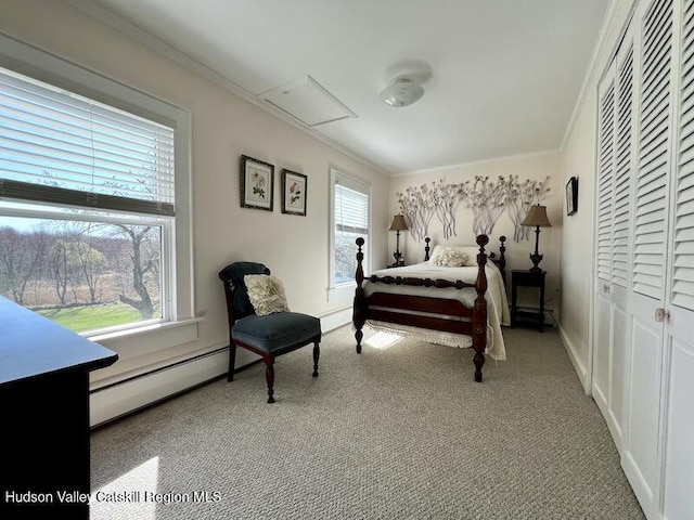 carpeted bedroom with a baseboard heating unit, crown molding, and a closet