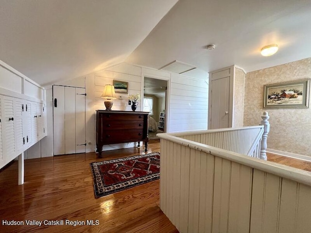 interior space featuring wood finished floors and lofted ceiling