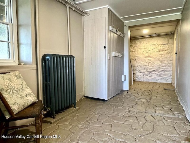 corridor with radiator and stone floors