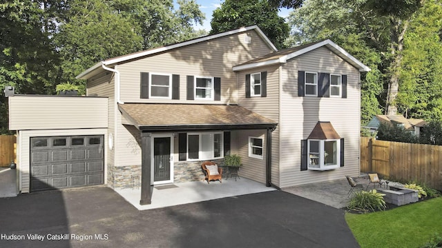 view of front of house featuring a patio area and a fire pit