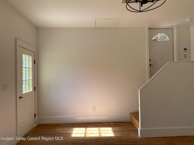 entrance foyer with hardwood / wood-style flooring and a notable chandelier