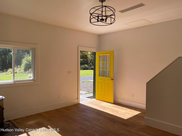 foyer featuring hardwood / wood-style floors and a chandelier