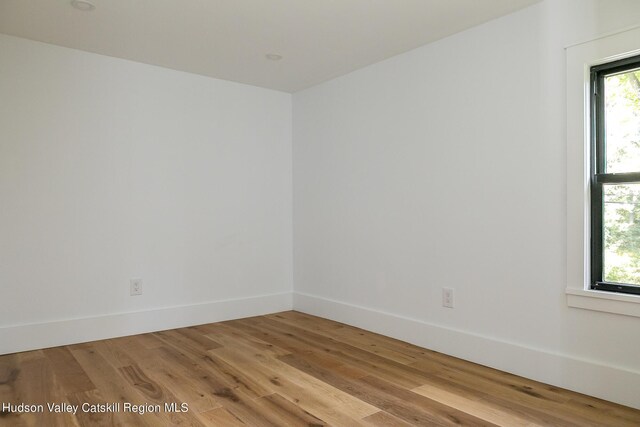 spare room featuring light hardwood / wood-style floors