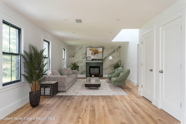 living room featuring a wealth of natural light and light hardwood / wood-style flooring