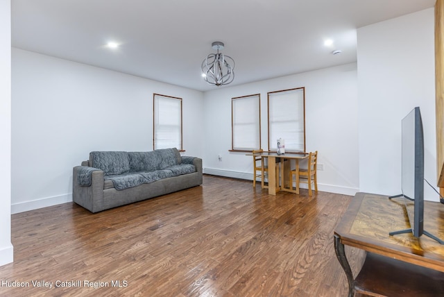 149 2nd St, Connelly, NY 12417 - living area with a chandelier, wood finished floors, baseboards, and a baseboard heating unit